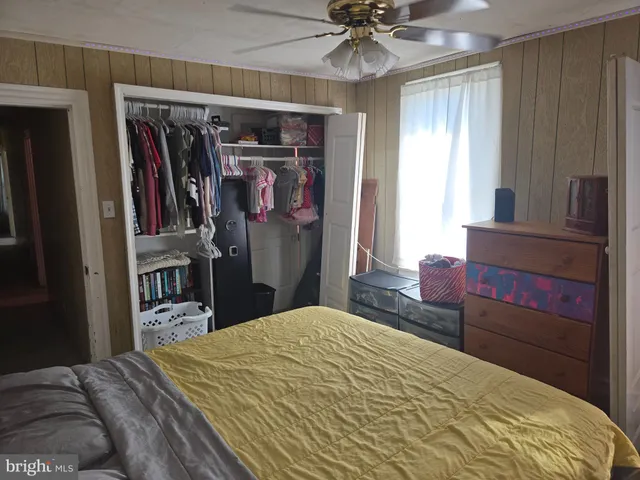 a bed room with a bed and a mirror