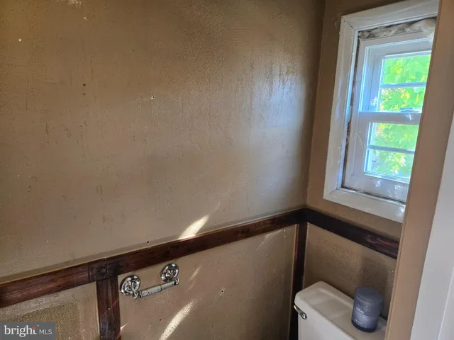 a view of a hallway with toilet