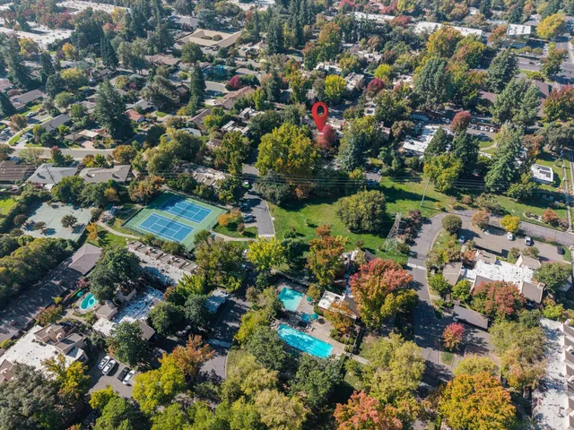 an aerial view of a house with a yard swimming pool a yard and lake view