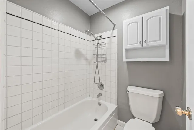 a bathroom with a toilet and shower
