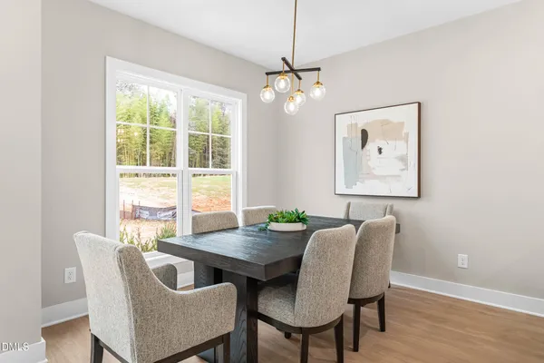 a large kitchen with a table and chairs