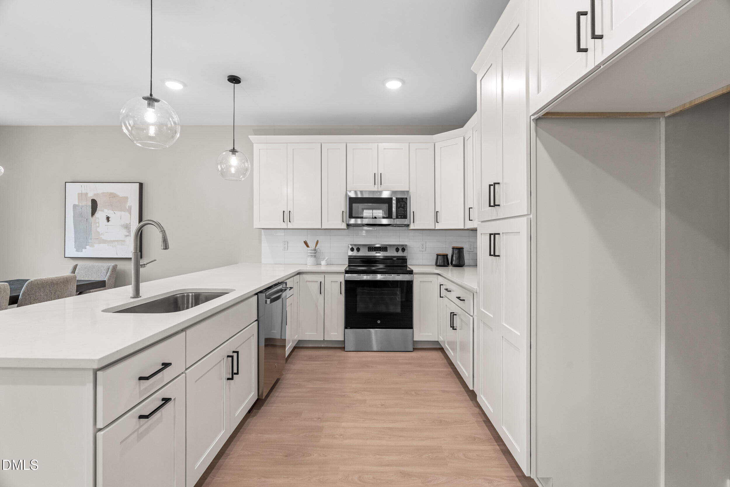1012 Harper Road Raleigh, NC 27603 - Photo 15 of 55 a kitchen with granite countertop white cabinets and white appliances