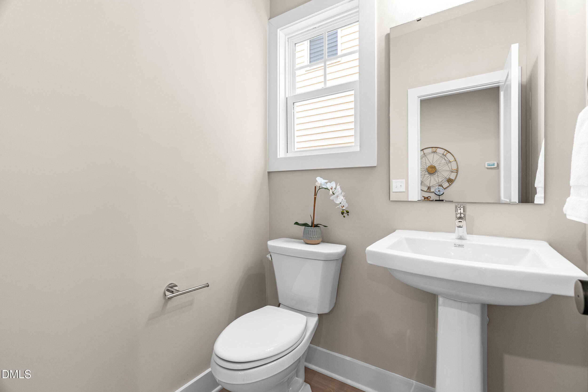 1012 Harper Road Raleigh, NC 27603 - Photo 17 of 54 a bathroom with a toilet sink and mirror