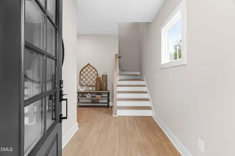 a view of entryway and hall with wooden floor