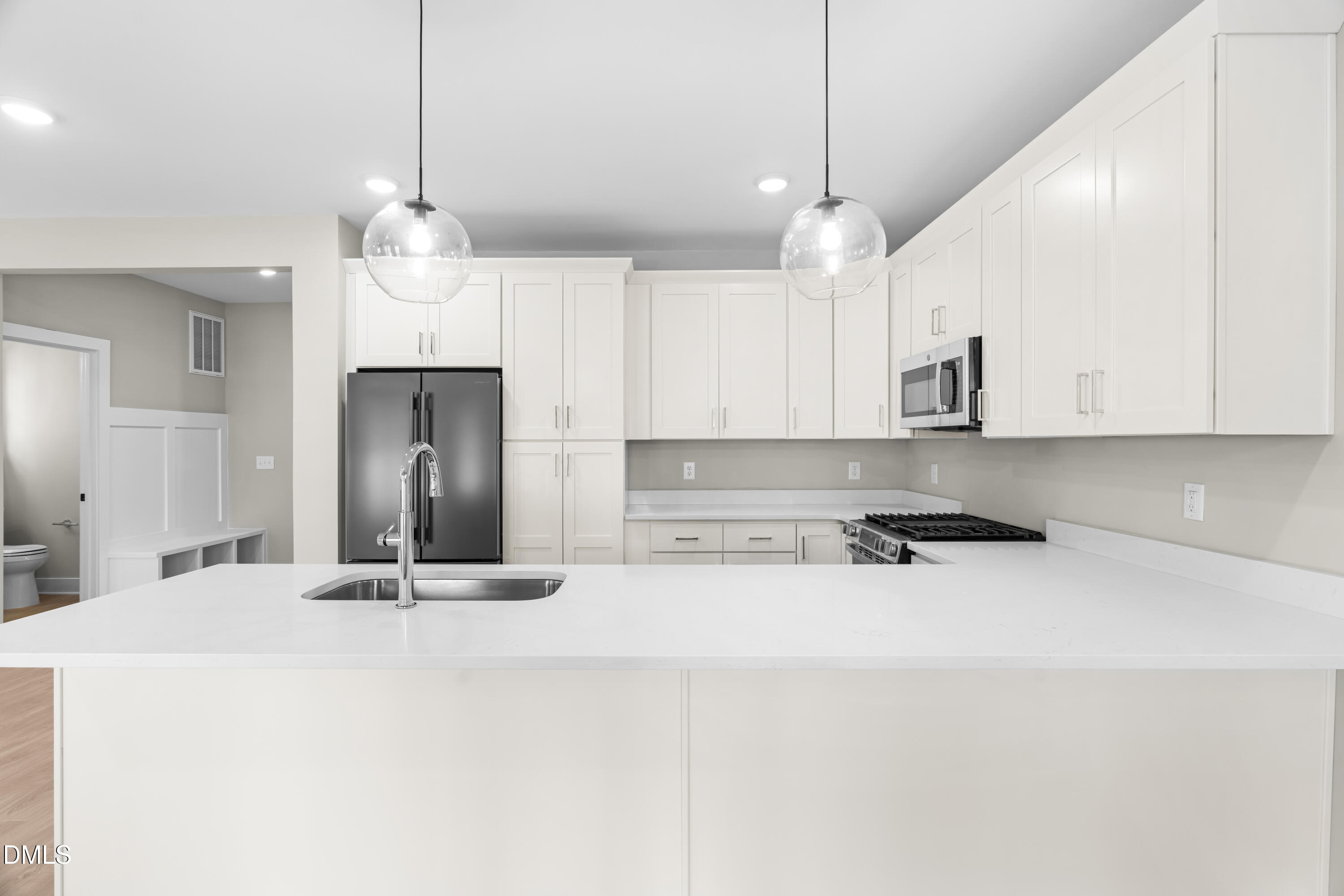1012 Harper Road Raleigh, NC 27603 - Photo 6 of 42 a kitchen with stainless steel appliances kitchen island a sink and a refrigerator
