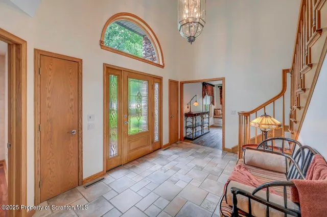a bathroom with a tub and a large window