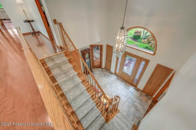 a aerial view of a house with table and chairs under an umbrella
