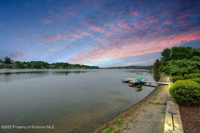 a kitchen with stainless steel appliances kitchen island granite countertop a stove a sink and a refrigerator