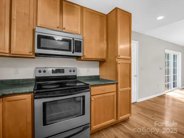 a kitchen with a stove microwave and sink