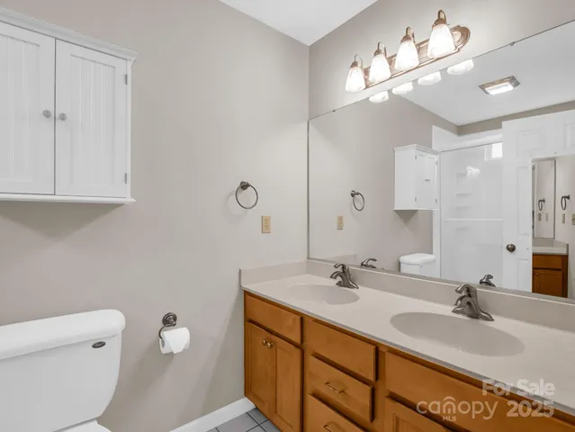 a bathroom with a double vanity sink and a mirror