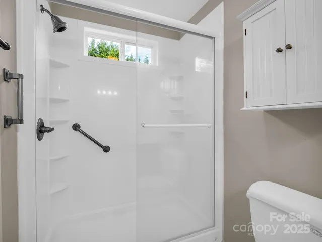 a bathroom with a shower and a toilet