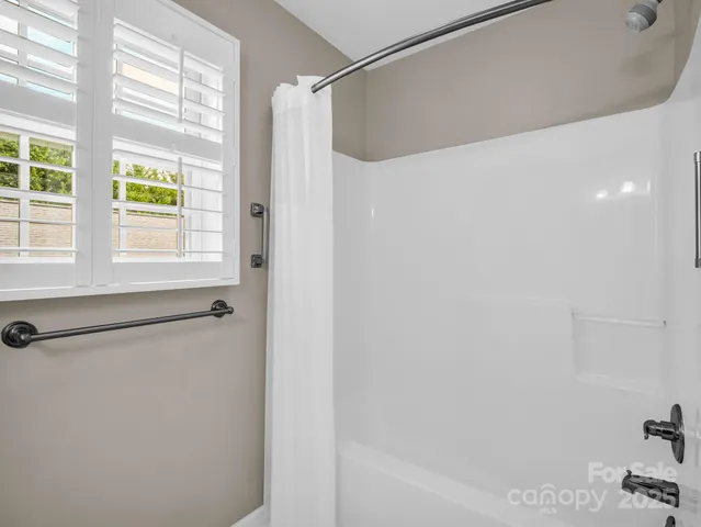 a bathroom with a shower and a bath tub