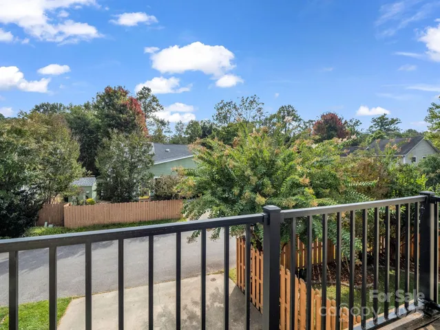 a view of a balcony with wooden fence