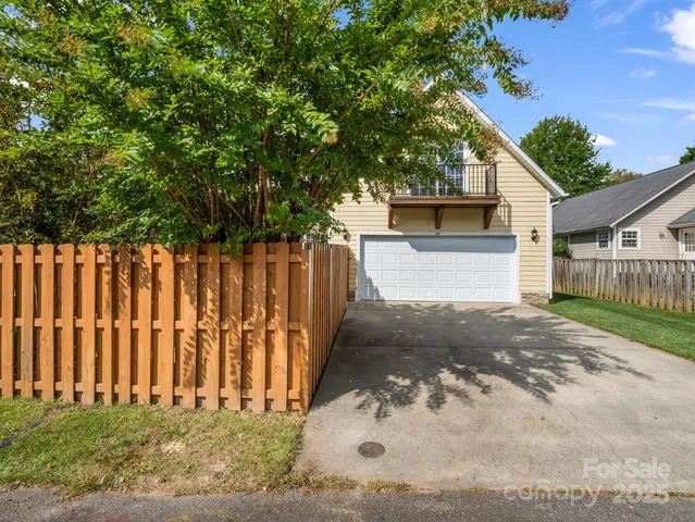 a view of a house with a wooden fence