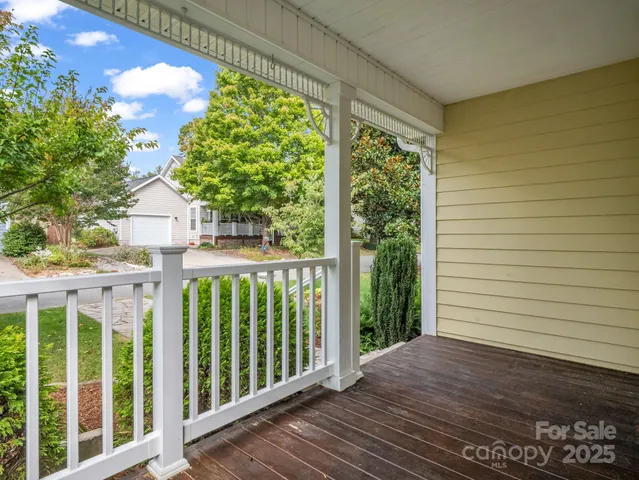 a view of a porch with wooden floor and fence