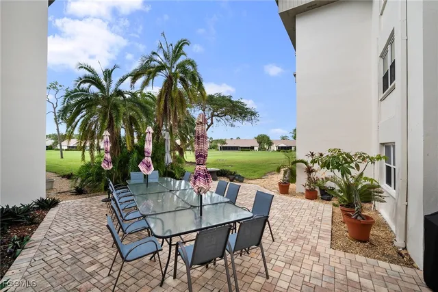 a view of a backyard with sitting area