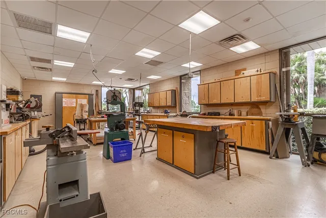 a room with pool table windows and wooden walls
