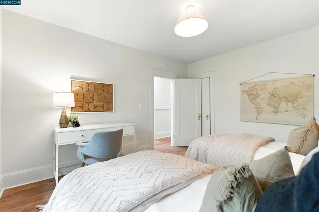 a bed room with two bed and a large window