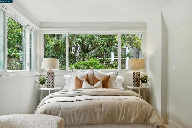 a bed room with furniture and a potted plant