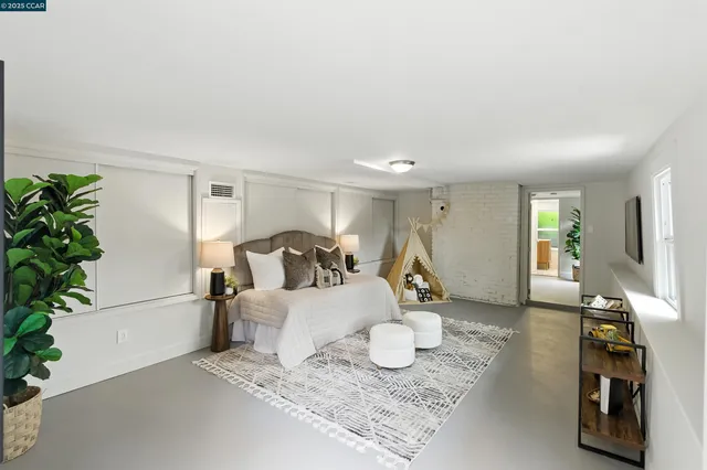 a living room with furniture and a potted plant