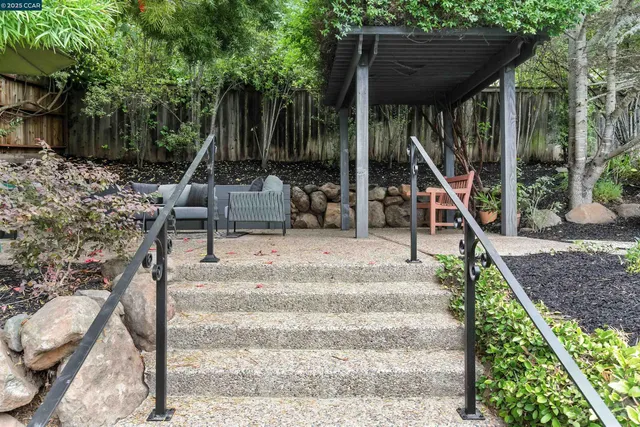 a view of a patio with table and chairs and potted plants