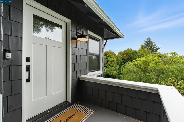 a living room with furniture a large window and a fireplace