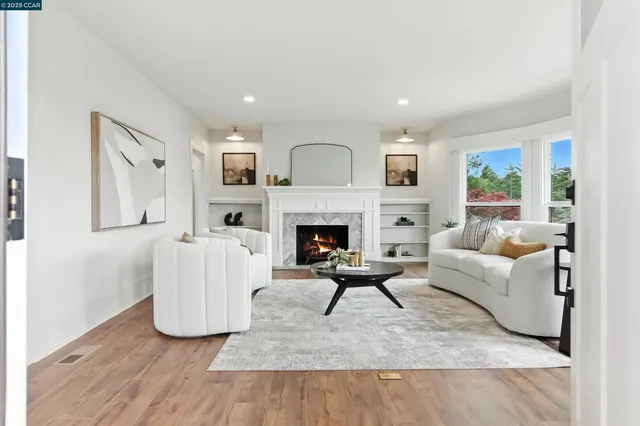 a living room with furniture and a fireplace