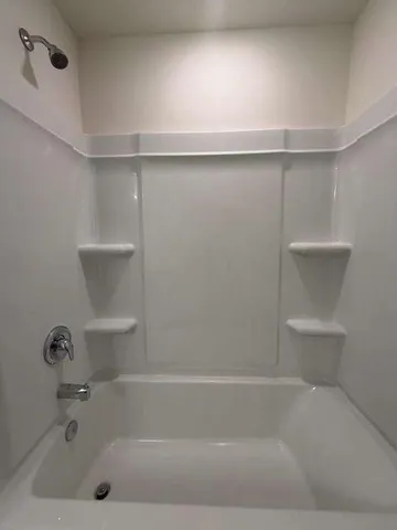 a bathroom with a sink a mirror and a shower