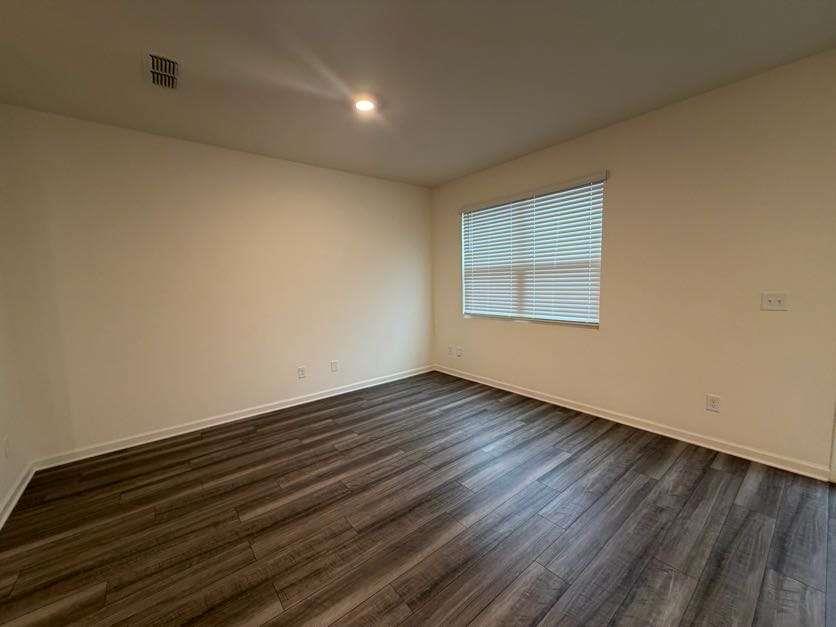 35300 Condor Court Atlanta, GA 30331 - Photo 3 of 31 an empty room with wooden floor and windows