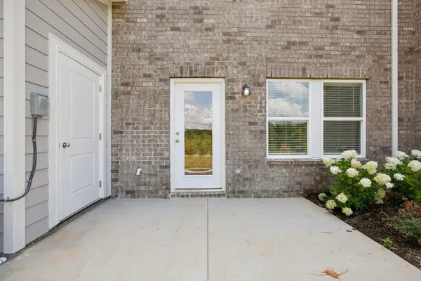 a view of a brick house with potted plants