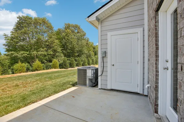 a view of a two chairs and a yard in the balcony