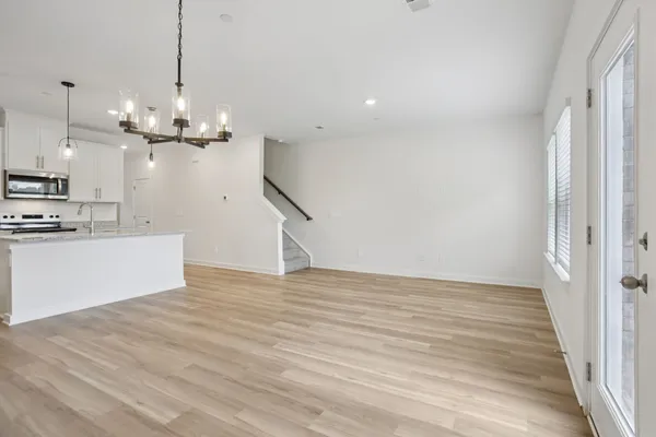 a view of a kitchen with a dishwasher and wooden floor