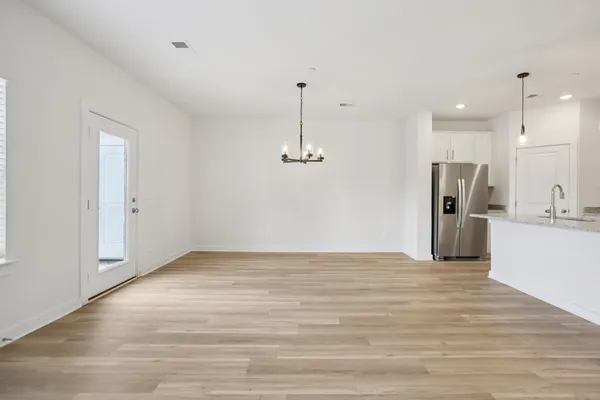 a view of a kitchen with a sink and refrigerator