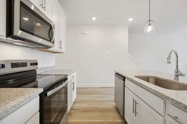 a kitchen that has a sink and a stove