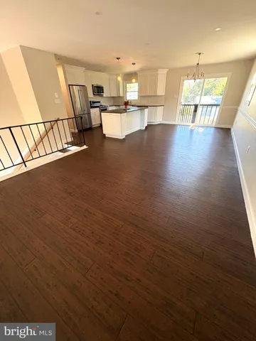 a view of wooden floor and windows in a room