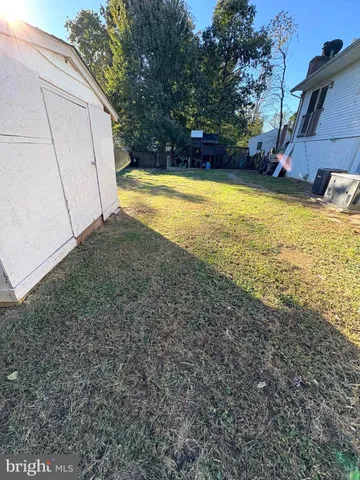 a view of a backyard with a large tree