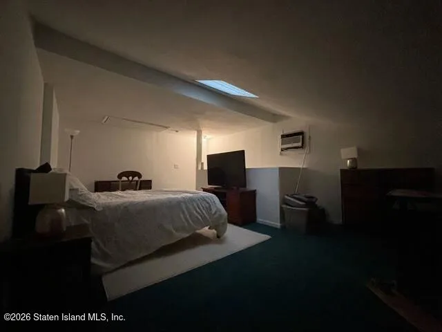 a bedroom with a bed and a television