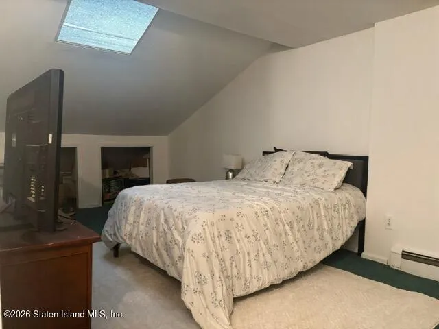 a bed sitting in a bedroom next to a lamp
