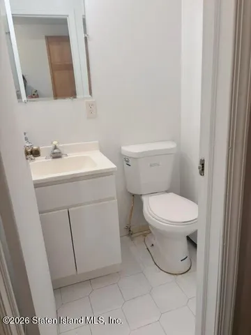 a white toilet sitting next to a bathroom sink