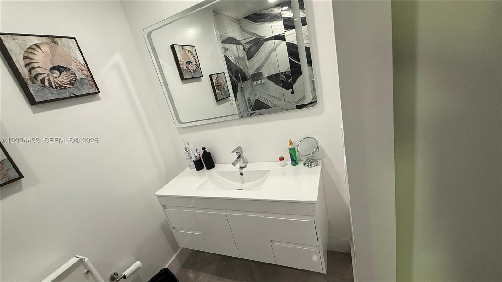 13675 Southwest 62nd Street, Unit 2023 Miami, FL 33183 - Photo 10 of 22 a bathroom with a sink and mirror