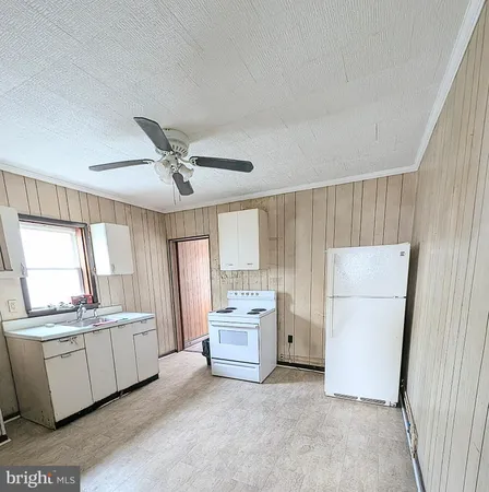 a kitchen with a refrigerator and a sink