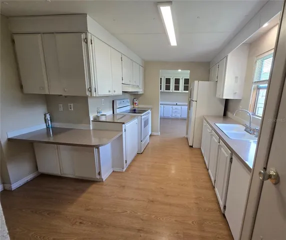 a kitchen with sink a counter top space and cabinets