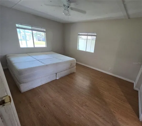 a spacious bedroom with a bed and a window
