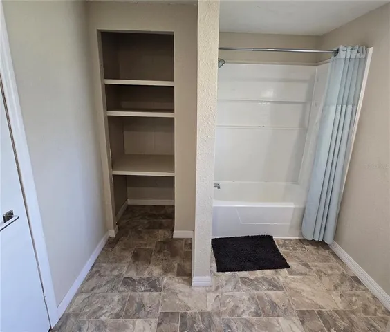 a bathroom with a bathtub and a shower
