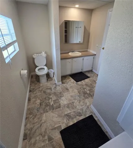 a bathroom with a sink toilet and mirror