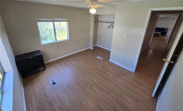 wooden floor in an empty room with a window