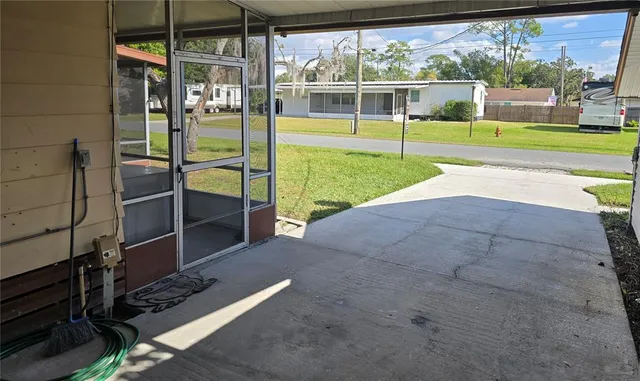 a view of a backyard with floor to ceiling window