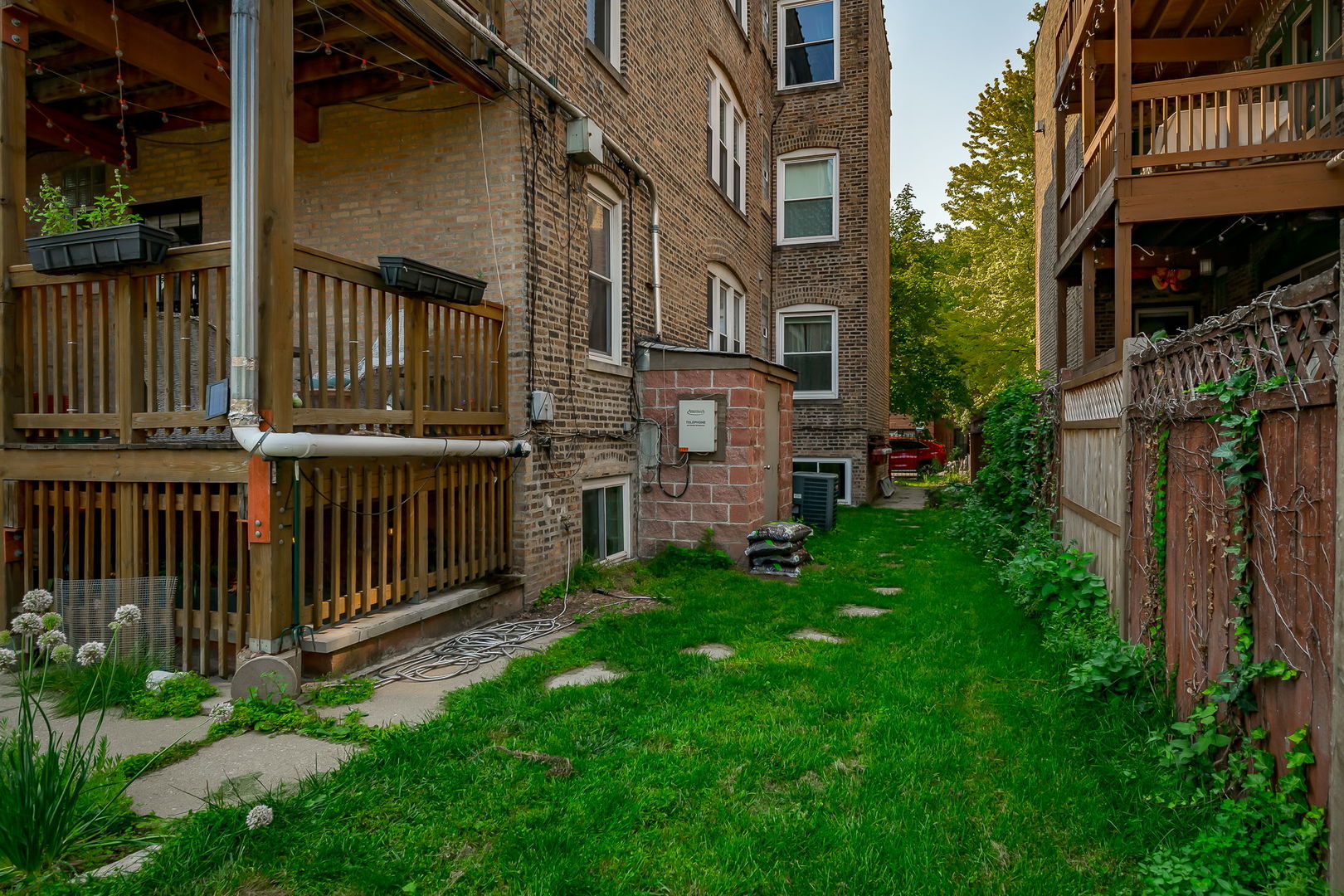 2749 North Spaulding Avenue, Unit GN Chicago, IL 60647 - Photo 28 of 40 a view of a house with brick walls and a fence