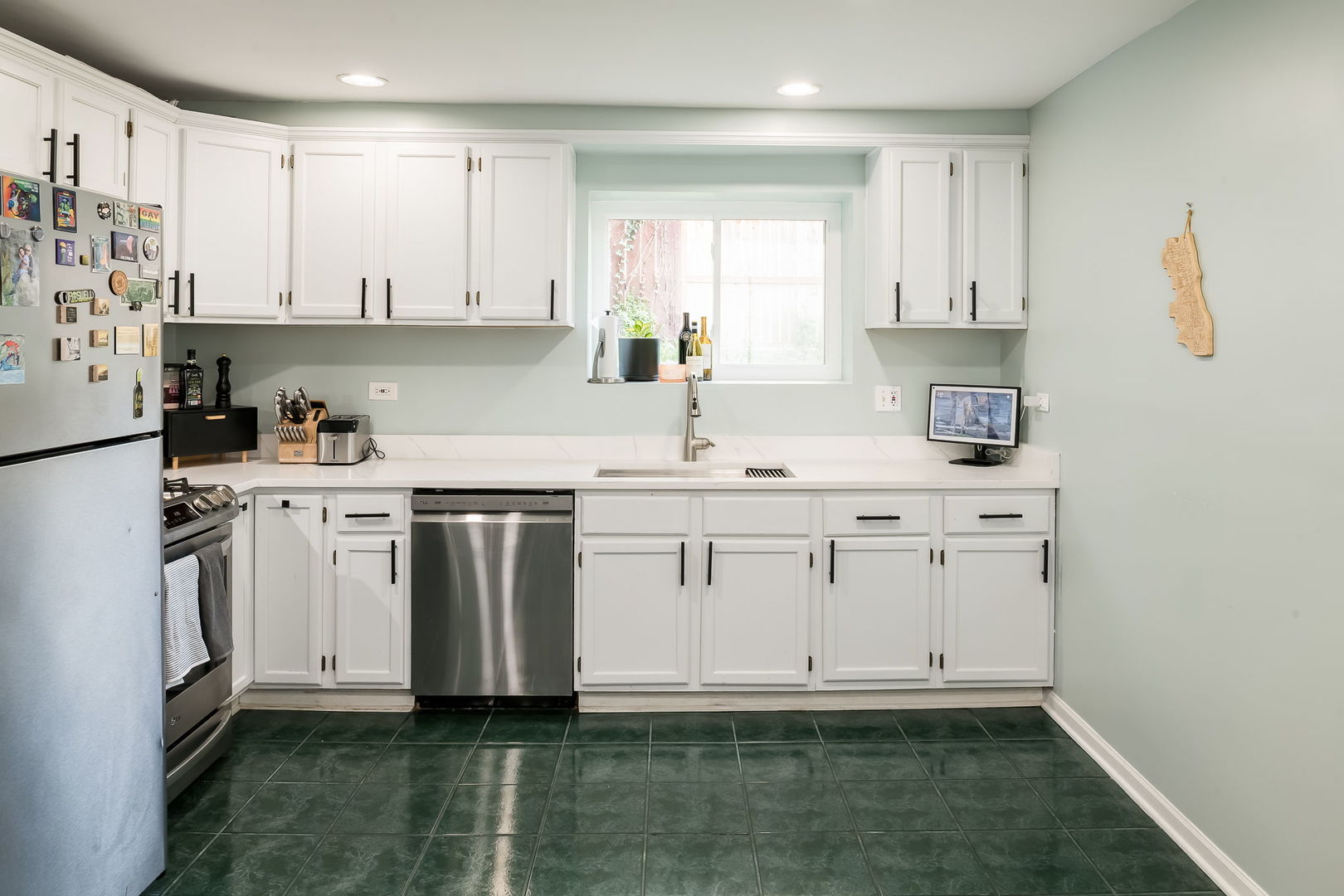 2749 North Spaulding Avenue, Unit GN Chicago, IL 60647 - Photo 4 of 40 a kitchen with white cabinets sink and stainless steel appliances