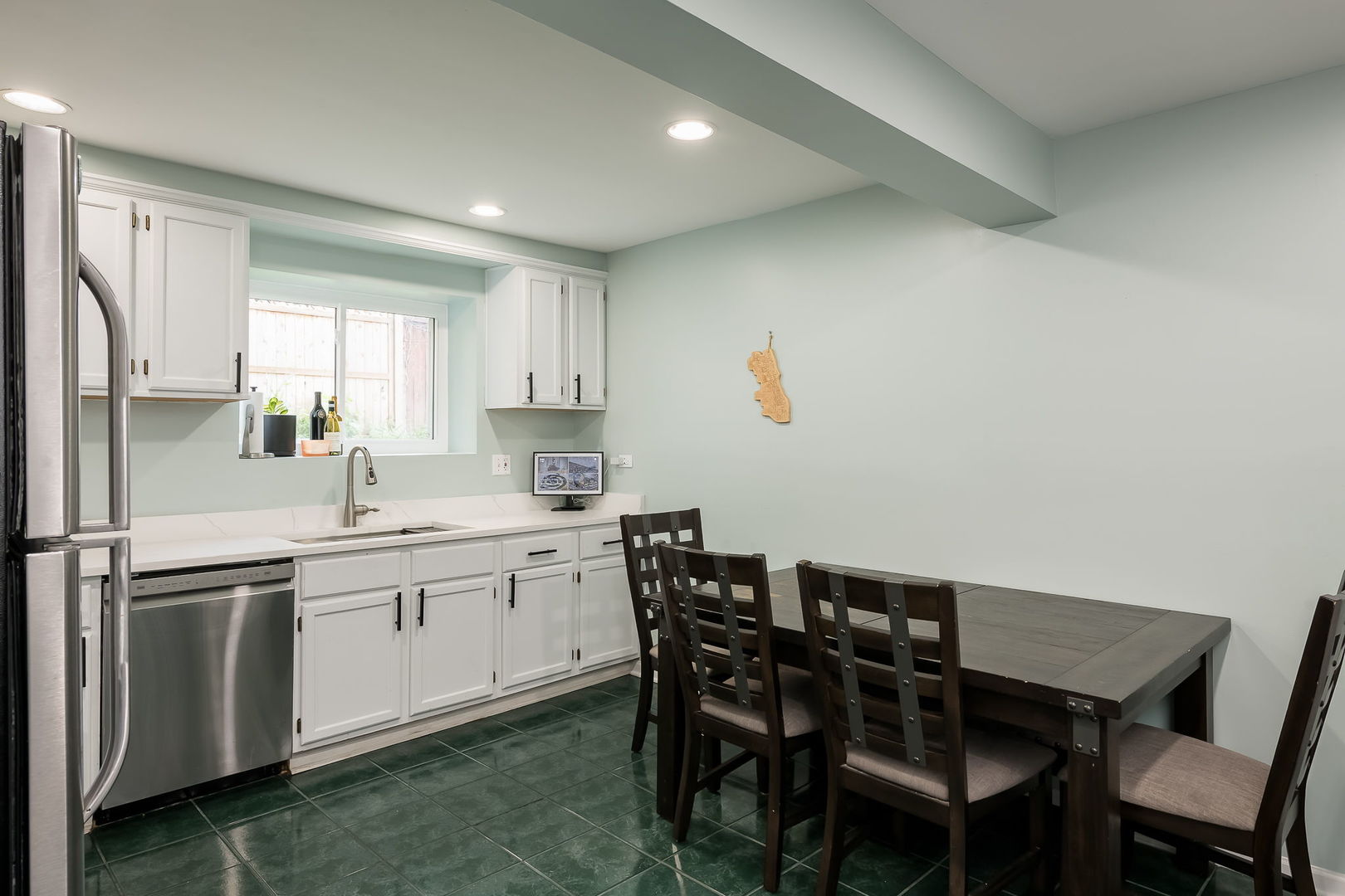 2749 North Spaulding Avenue, Unit GN Chicago, IL 60647 - Photo 6 of 40 a kitchen with a table chairs sink and cabinets